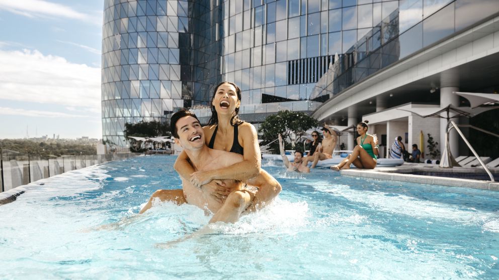 Couple enjoying the luxurious pool at Crown Towers hotel, Crown Sydney, Barangaroo