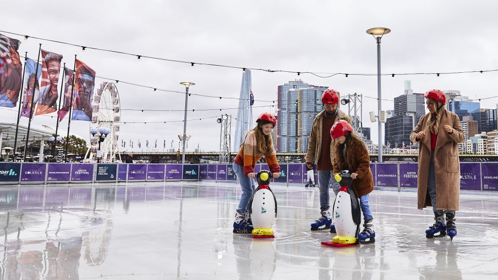 Family enjoying a winter ice skating session at Darling Harbour, Sydney City