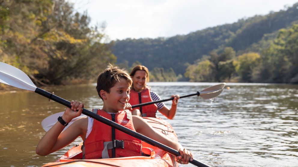 Family enjoying a day of kayaking along Hawkesbury River, near Lower MacDonald