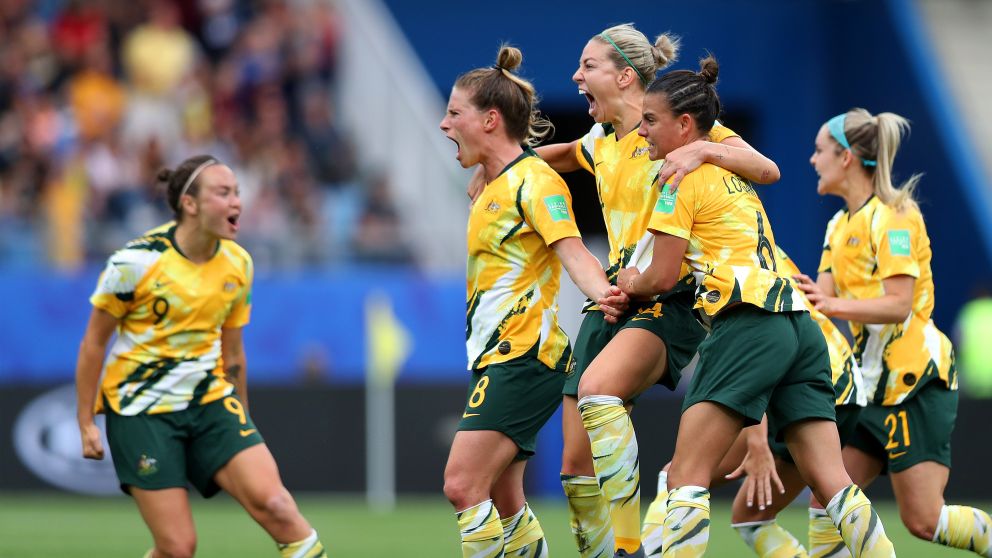 Australia players celebrate after their team's third goal - Credit: Naomi Baker - FIFA/FIFA via Getty Images