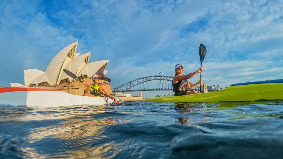 Kayakers enjoying Sydney harbour near the Sydney Opera House with the Sydney Harbour Bridge in the background, Sydney Harbour