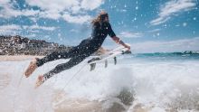 Bronte Beach, Sydney Surfer heading out to catch a wave at Bronte Beach, Sydney