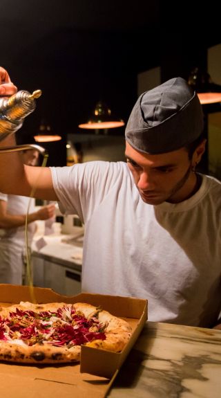 Chef preparing pizza's at Gigi Pizzeria in Newtown, Sydney