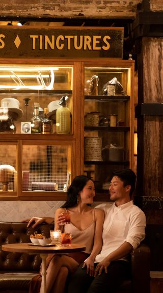 Couple enjoying bar snacks and cocktails at Palmer and Co., Sydney