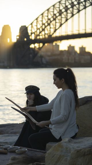 Woman learning about Aboriginal culture on a tour with Aboriginal Cultural Tours, Barangaroo Reserve, Sydney City