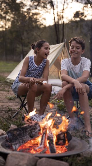 Children enjoying a campfire by their tent on the Hawkesbury River in Lower MacDonald