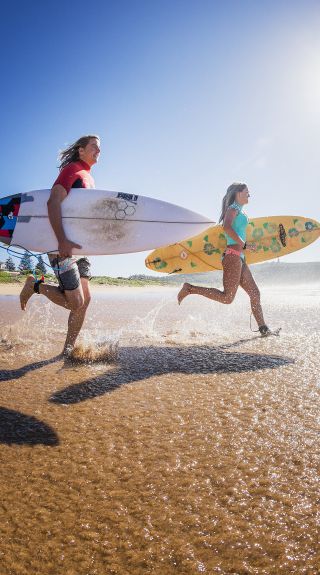 Two surfers heading out to enjoy the morning waves at Sydney's Palm Beach