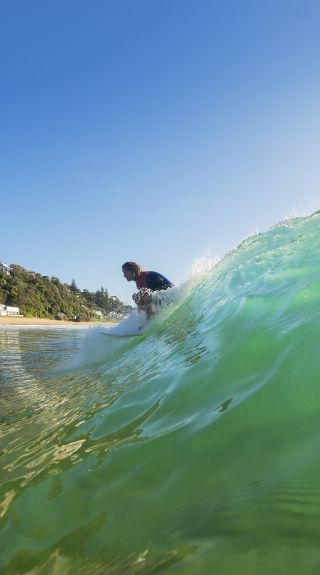 Man enjoying a morning surf at Sydney's Palm Beach