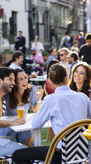 Friends enjoying drinks in the afternoon at the Orient Hotel in The Rocks, Sydney City