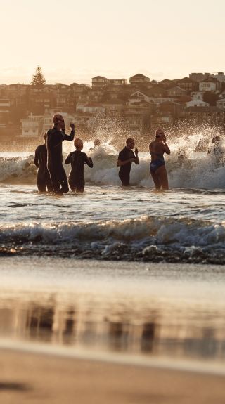Swimmers heading out into the ocean from Bondi Beach, Sydney East