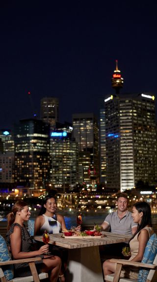 Guests enjoying evening cocktails at Le Rivage Pool Bar, Sofitel overlooking Darling Harbour