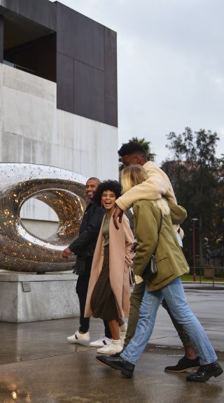 Friends arriving outside the Museum of Contemporary Art Australia in The Rocks, Sydney City