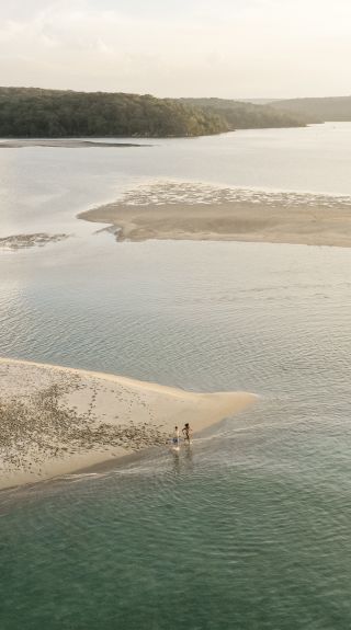 Couple enjoying a private scenic picnic set up along the Hacking River by Boats & Baskets