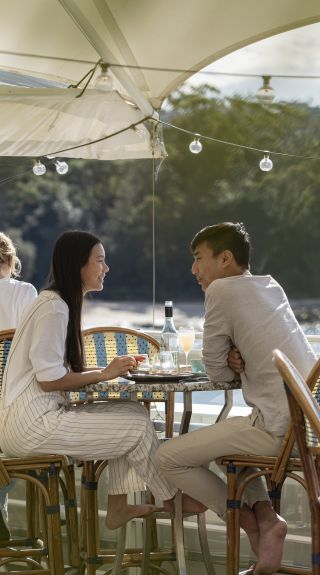 Couple enjoying food and drink with views of Balmoral Beach at Bathers Pavilion, Mosman