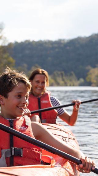 Family enjoying a day of kayaking along Hawkesbury River, near Lower MacDonald