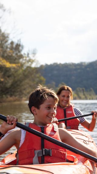 Family enjoying a day of kayaking along Hawkesbury River, near Lower MacDonald