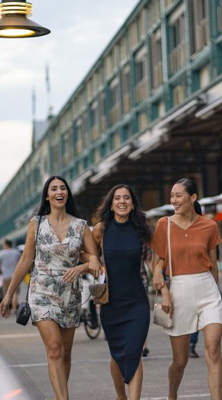 Friends walking along the Finger Wharf at Woolloomooloo, Sydney City