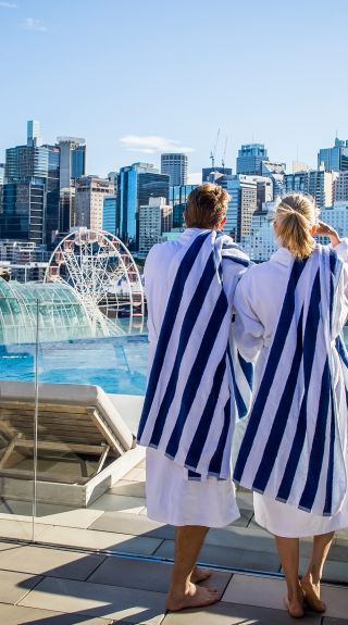 Couple enjoying Sofitel Sydney's rooftop pool, Darling Harbour