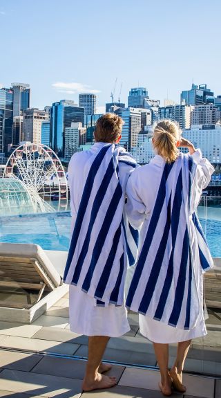 Couple enjoying Sofitel Sydney's rooftop pool, Darling Harbour