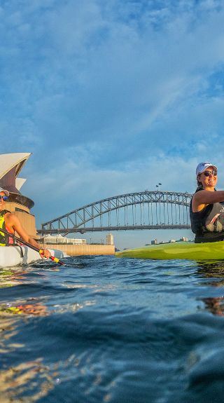 Kayakers enjoying Sydney harbour near the Sydney Opera House with the Sydney Harbour Bridge in the background, Sydney Harbour