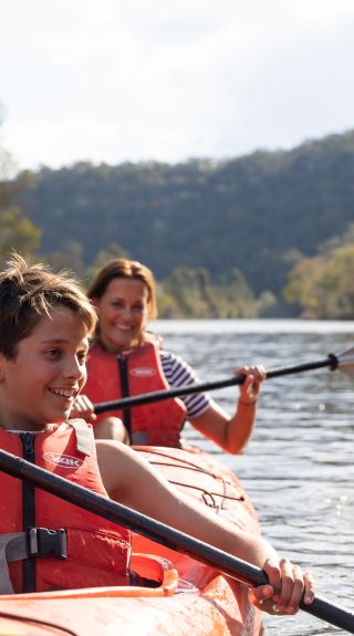 Mother and son enjoying a day of kayaking along Hawkesbury River, near Lower MacDonald