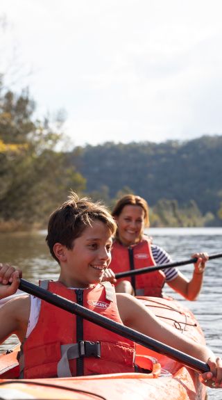 Mother and son enjoying a day of kayaking along Hawkesbury River, near Lower MacDonald