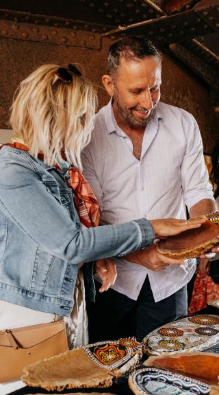 Couple browsing through Aboriginal artwork for sale, Blak Markets, Bare Island, La Perouse