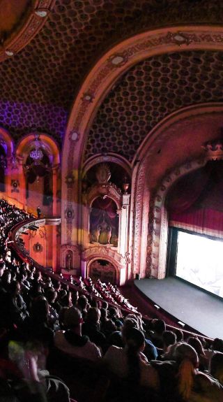 Audience in a grand theatre watching a film for the Sydney Film Festival 