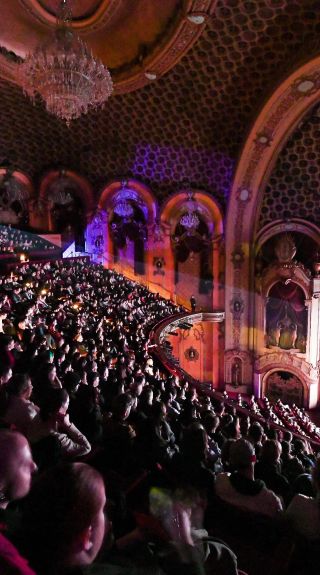 Audience in a grand theatre watching a film for the Sydney Film Festival 