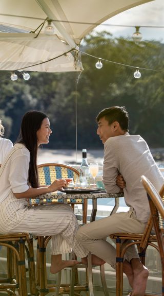 Couple enjoying food and drink, Bathers Pavilion, Mosman