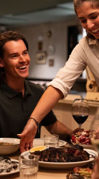 Friends enjoy a meal with wine, Bistecca, Sydney