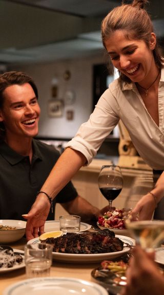 Friends enjoy a meal with wine, Bistecca, Sydney