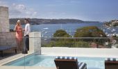 Couple enjoying drinks by the pool at the Intercontinental Hotel in Double Bay 