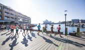 Participants in the Blackmores Sydney Running Festival passing through Campbells Cove with views of the Sydney Opera House