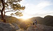 Couple watching a scenic sunset over the Hawkesbury Valley from the Vale of Avoca lookout in Grose Vale