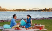 Couple having a picnic by the water on Cockatoo Island, Sydney