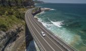 A car driving across the Sea Cliff Bridge, near Clifton