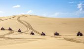 Small group enjoying an Aboriginal cultural tour on quad bikes with Sand Dune Adventures, Port Stephens