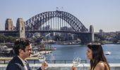 Couple enjoying food and drink with harbour views at Cafe Sydney, Sydney