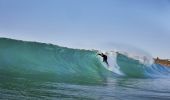 Surfer catches a wave at Mona Vale Beach