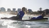 Couple enjoying a surf lesson with Lets Go Surfing, Bondi Beach