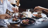 Couple enjoying food and drink at The Butler, an open patio bar located on Victoria Street, Potts Point