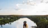 Woman enjoying scenic views across the Hawkesbury River from the Cooks Co-Op lookout, Sackville