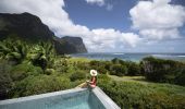 Woman relaxing by the pool at Capella Lodge, Lord Howe Island
