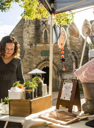 Woman browsing homewares at Balmain Markets, in Balmain