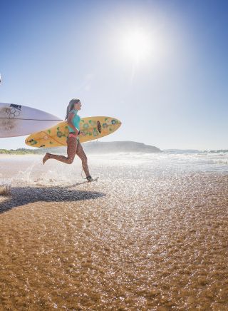 Two surfers heading out to enjoy the morning waves at Sydney's Palm Beach.