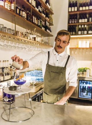 Bartender at love.fish Barangaroo creates a Vivid Sydney inspired cocktail.