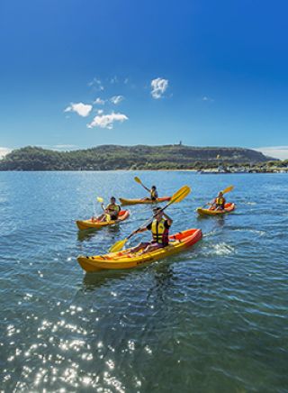 Friends kayaking on Pittwater near the Boathouse in Palm Beach