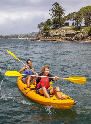 Couple enjoying a day of kayaking on Sydney Harbour