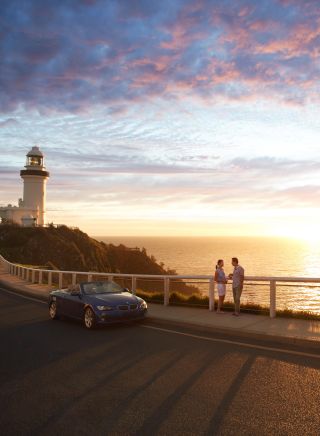 A couple enjoying sunrise at the Cape Byron Bay Lighthouse, Byron Bay